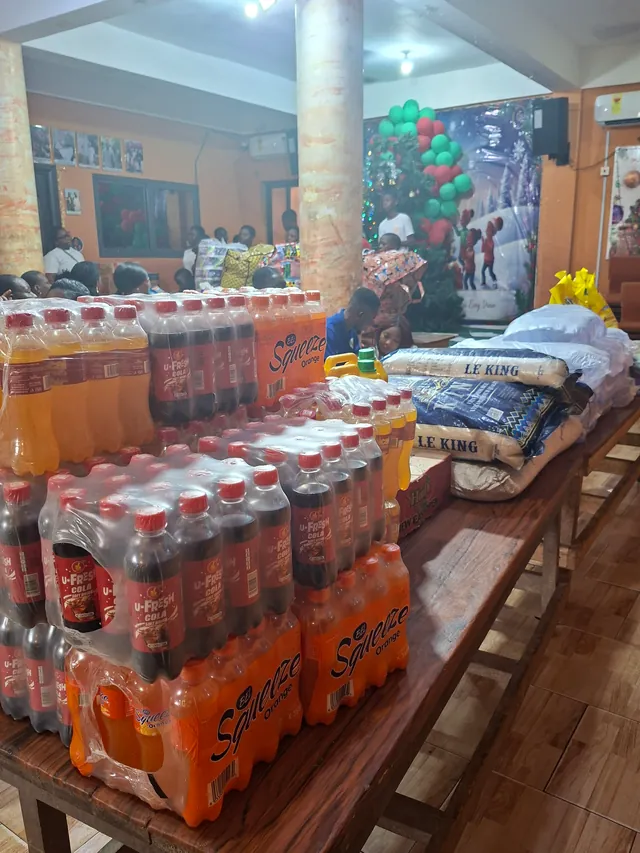 Crates of drinks and bags of rice laid out for a donation
