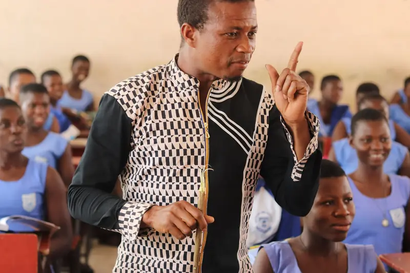 A teacher leading a lively lesson in a classroom
