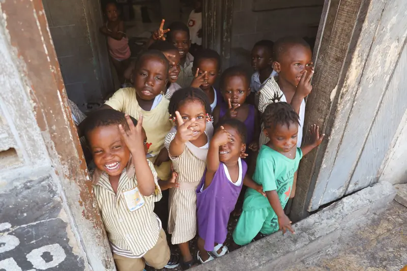 A group of happy children posing in a doorway
