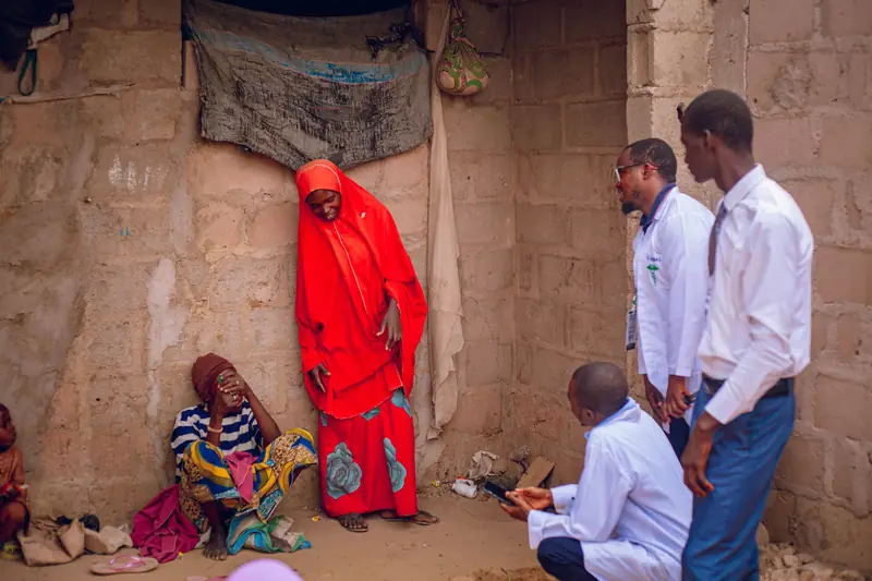 Health workers meeting villagers in a rural community