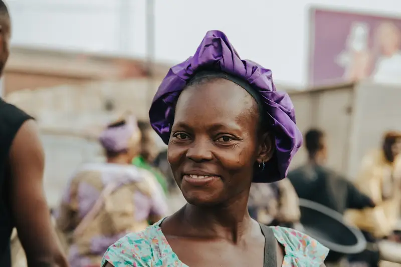 A smiling woman at a colourful market
